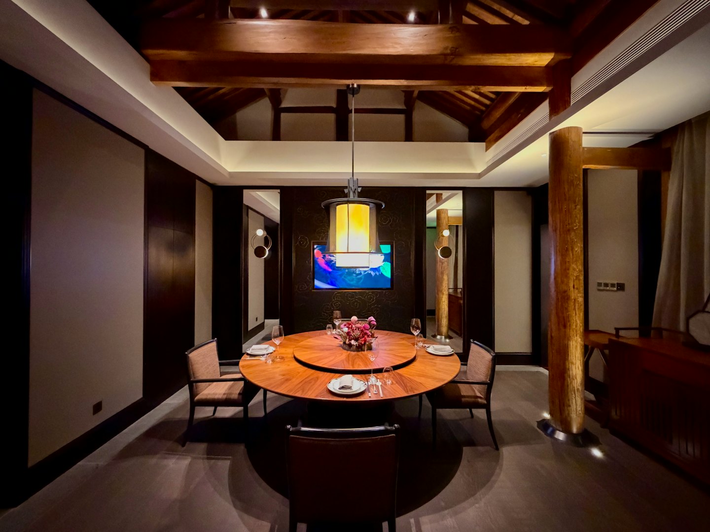 Private dining room with a round table set for guests.